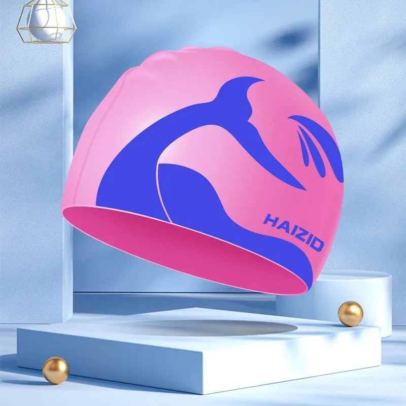 Silicone swimming cap with raised whale tail pattern and integrated ear protectors in multiple colour options