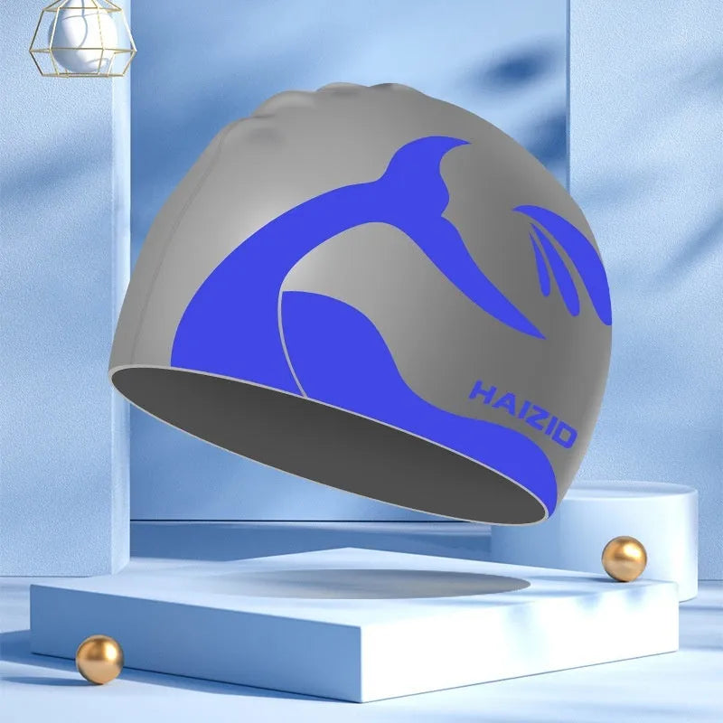 Silicone swimming cap with raised whale tail pattern and integrated ear protectors in multiple colour options