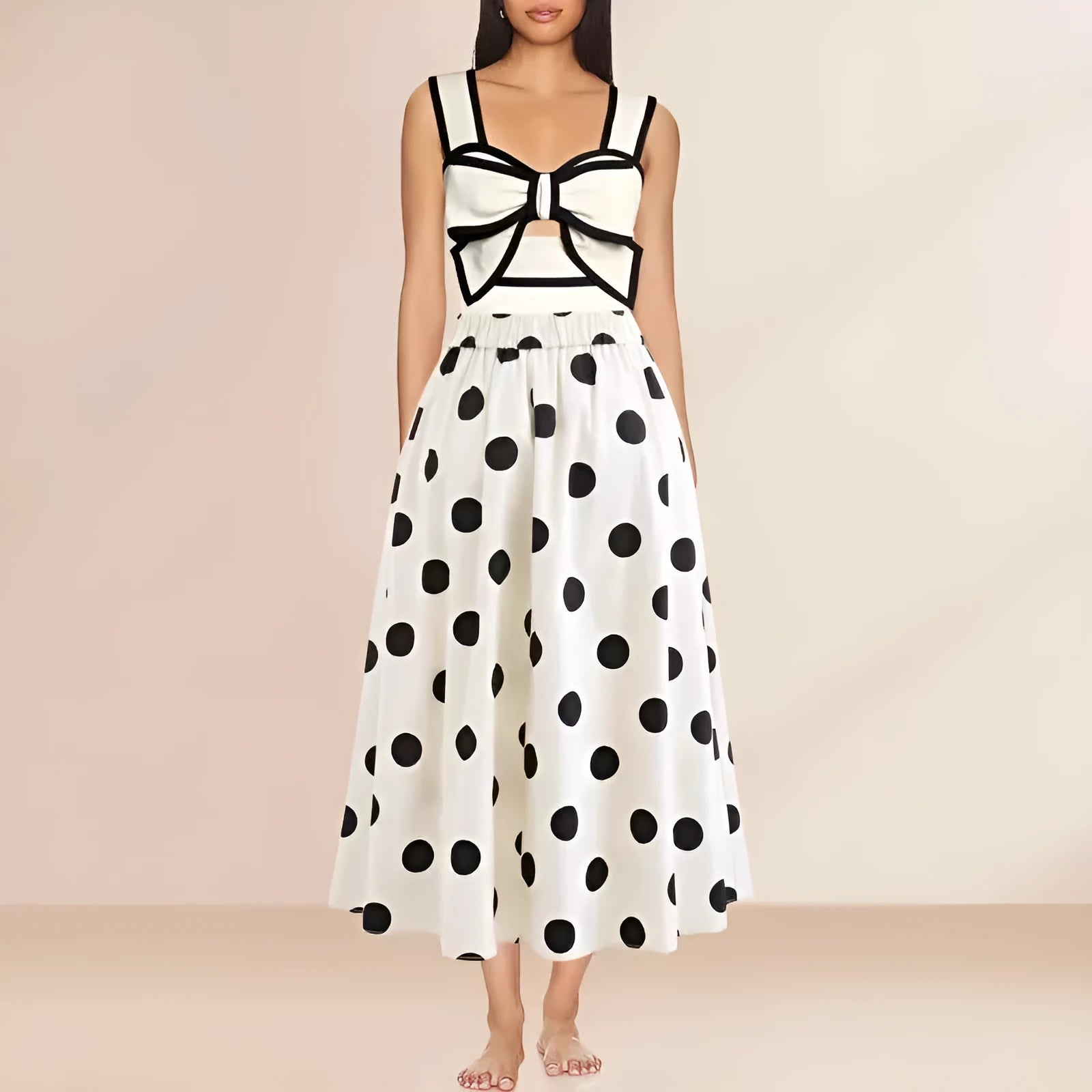 Women's black one-piece swimsuit with a white round skirt and bow detail on the front.