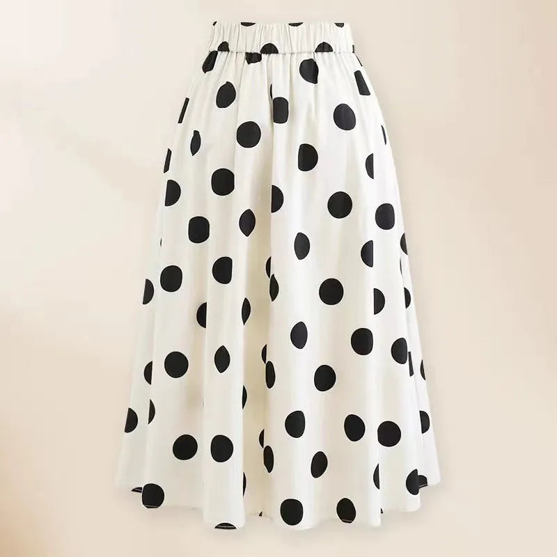 Women's black one-piece swimsuit with a white round skirt and bow detail on the front.