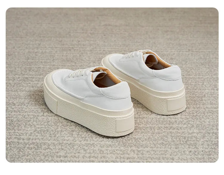 Women's black embossed cowhide leather platform sports board shoes with a round toe and white rubber sole.