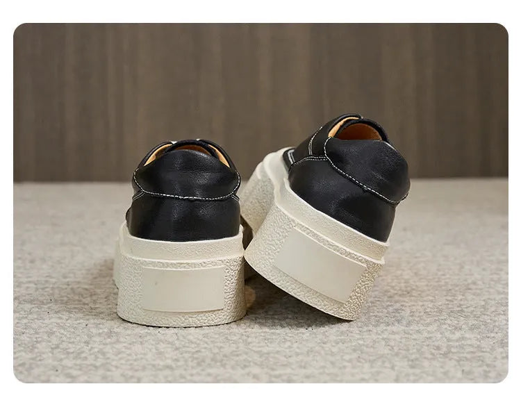 Women's black embossed cowhide leather platform sports board shoes with a round toe and white rubber sole.