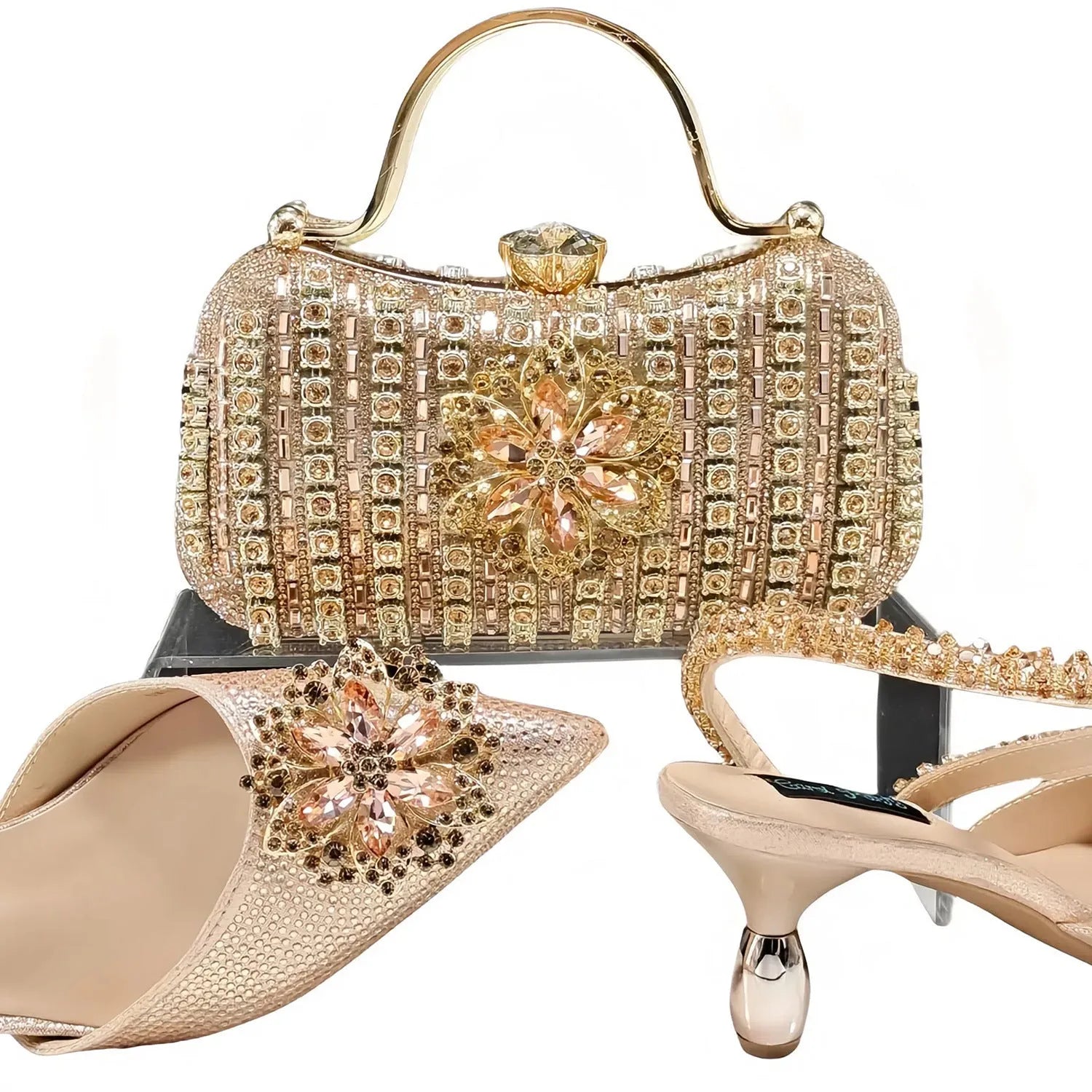 Women's black high heel ankle strap sandal with rhinestone flower and matching clutch bag.
