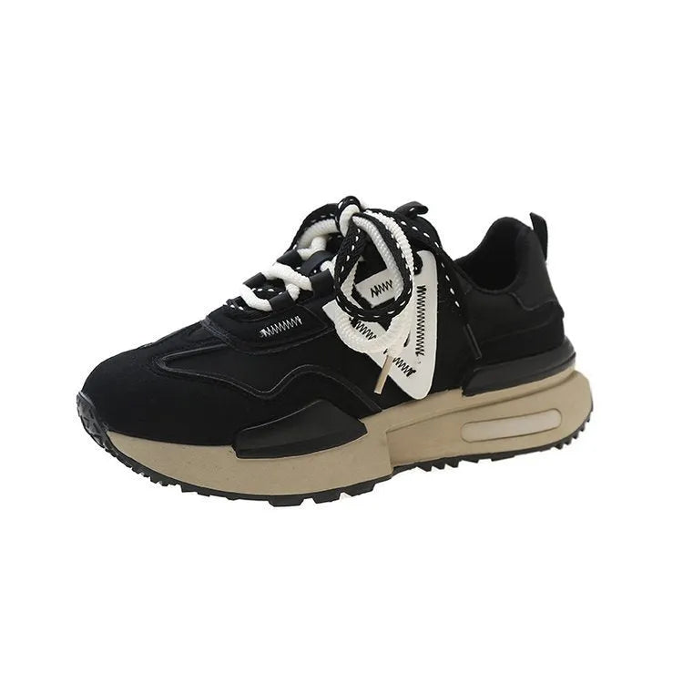 Women's black retro platform sports shoes with round toe and lace-up fastening on a neutral background.