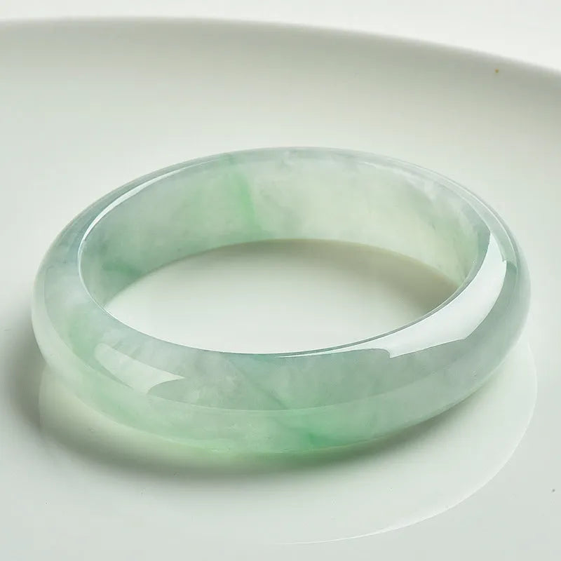 Light green jade bracelet with smooth surface showing natural stone texture