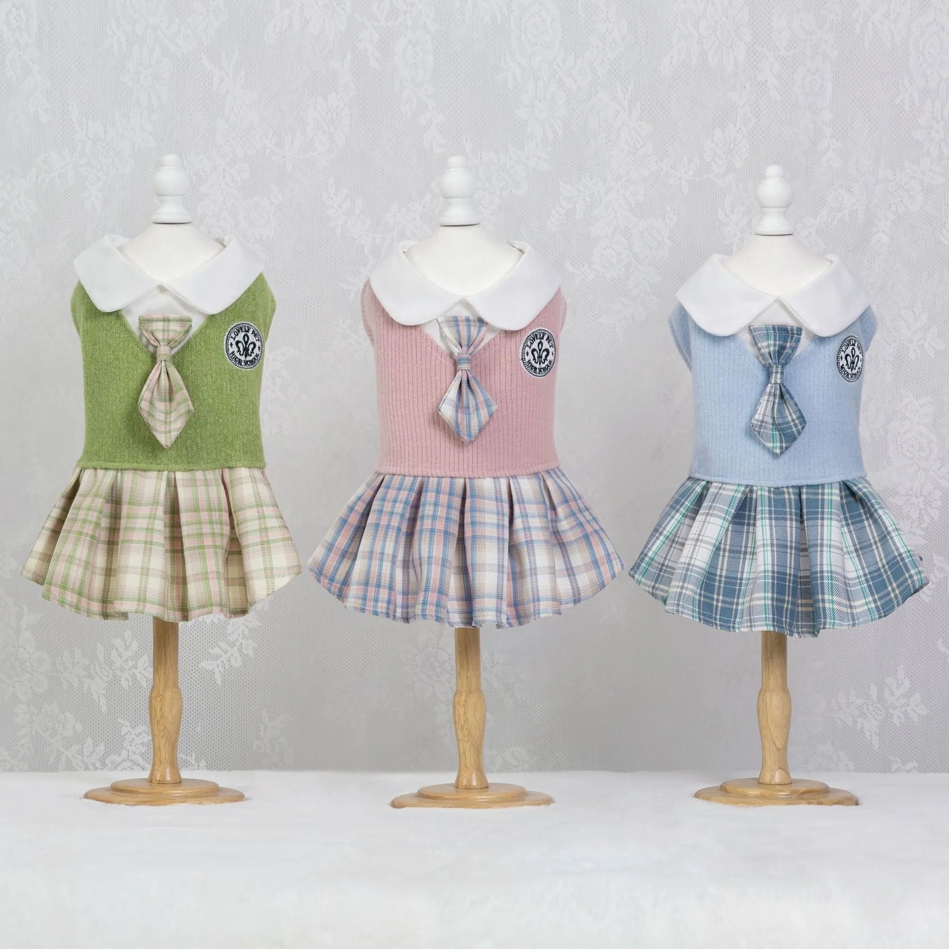 A pink tartan skirt with princess styling designed for a small dog to wear.