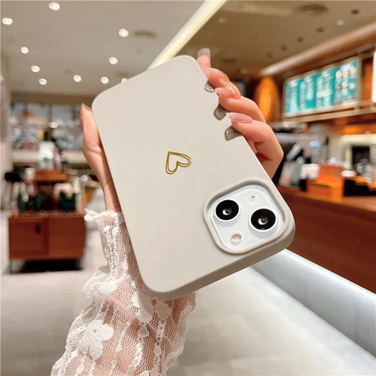 Brown soft silicone iPhone case with a simple cartoon ins style design on a table.