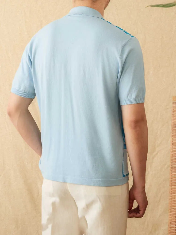 Man wearing a royal blue striped short-sleeved cardigan polo shirt with a lapel collar.