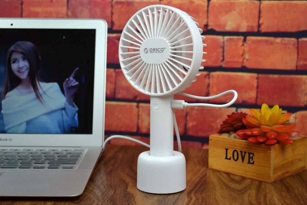 White ORICO FH1 portable USB rechargeable fan with three-speed control on desktop