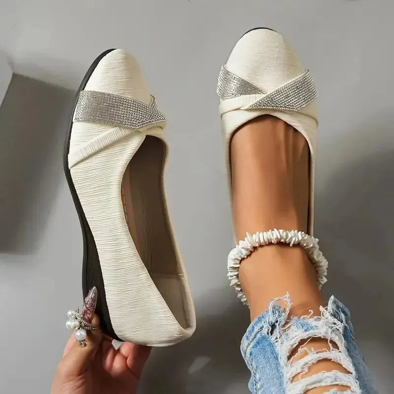 Black women's slip-on casual shoes with a chunky heel and rhinestone details on the fabric upper.