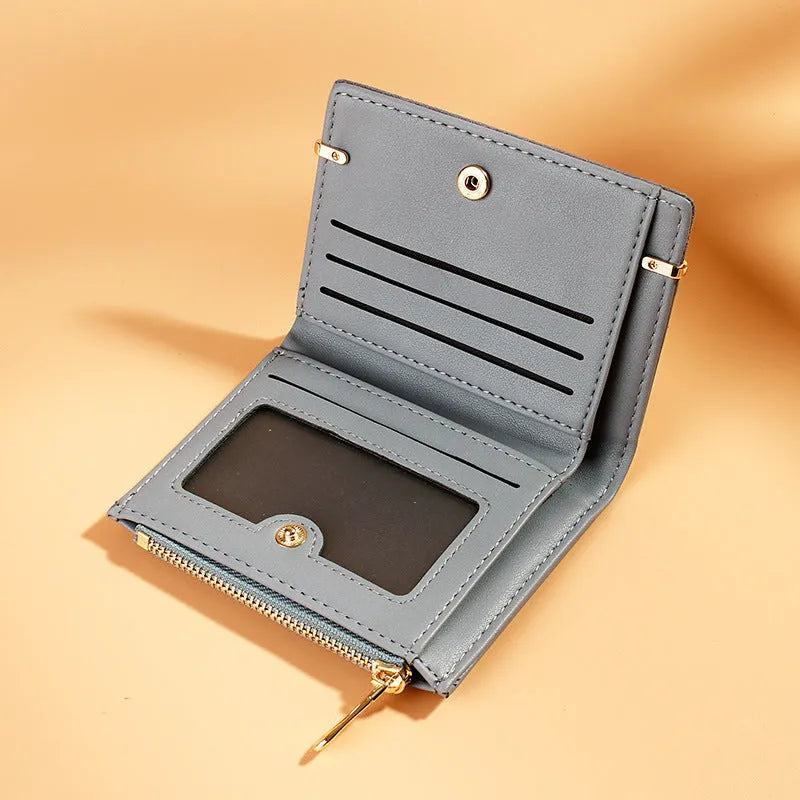 Open view of a folded ladies PU leather wallet showing card slots, a zippered compartment, a bill holder, and a photo slot.