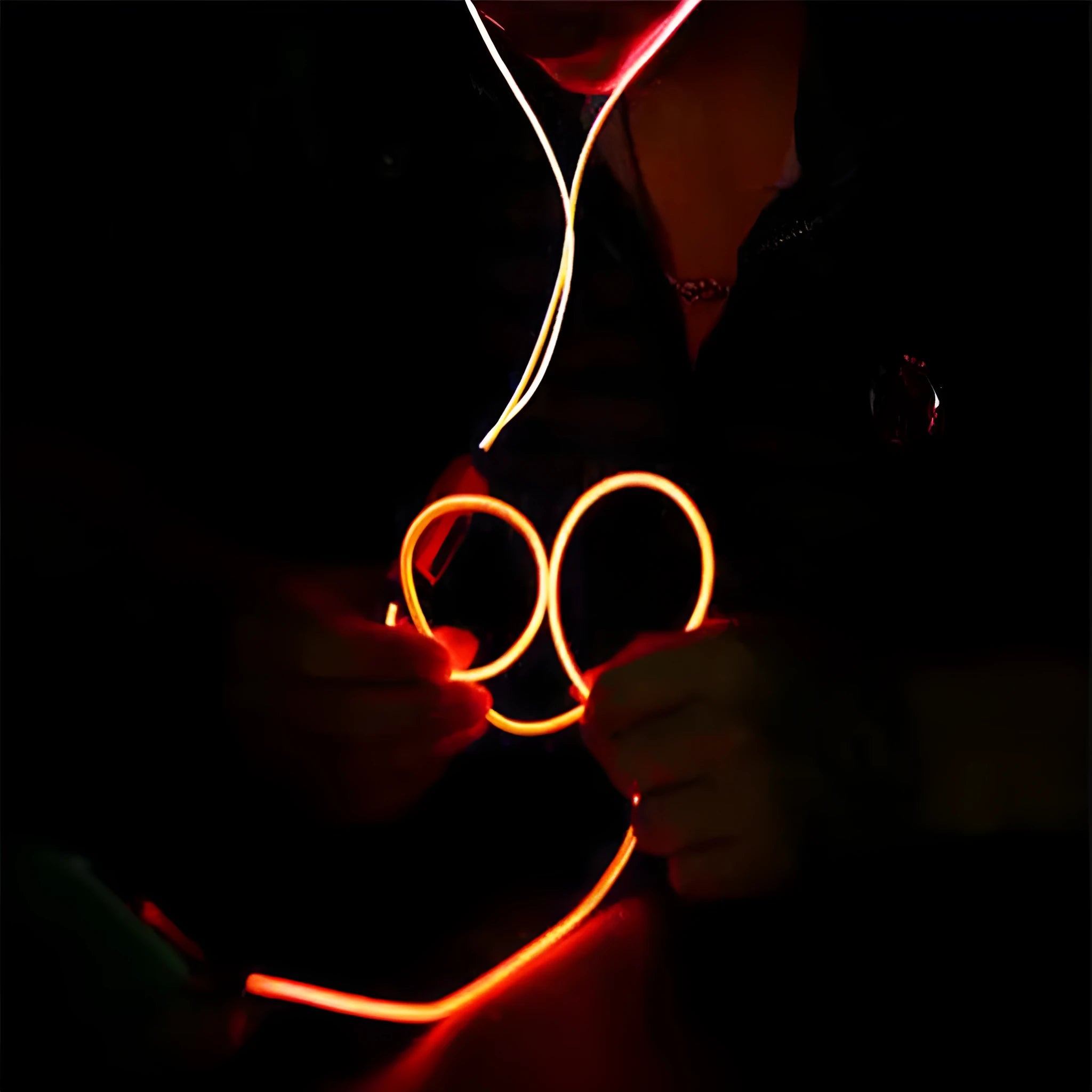Blue LED light up earphones with 3.5mm plug and inline remote control on a dark background.