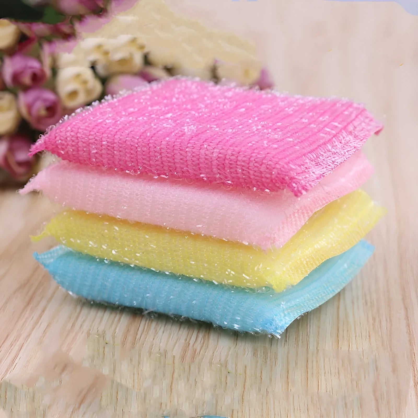 Macaron coloured pinstripe fabric dishwashing sponge mop with plastic handle on a kitchen surface.
