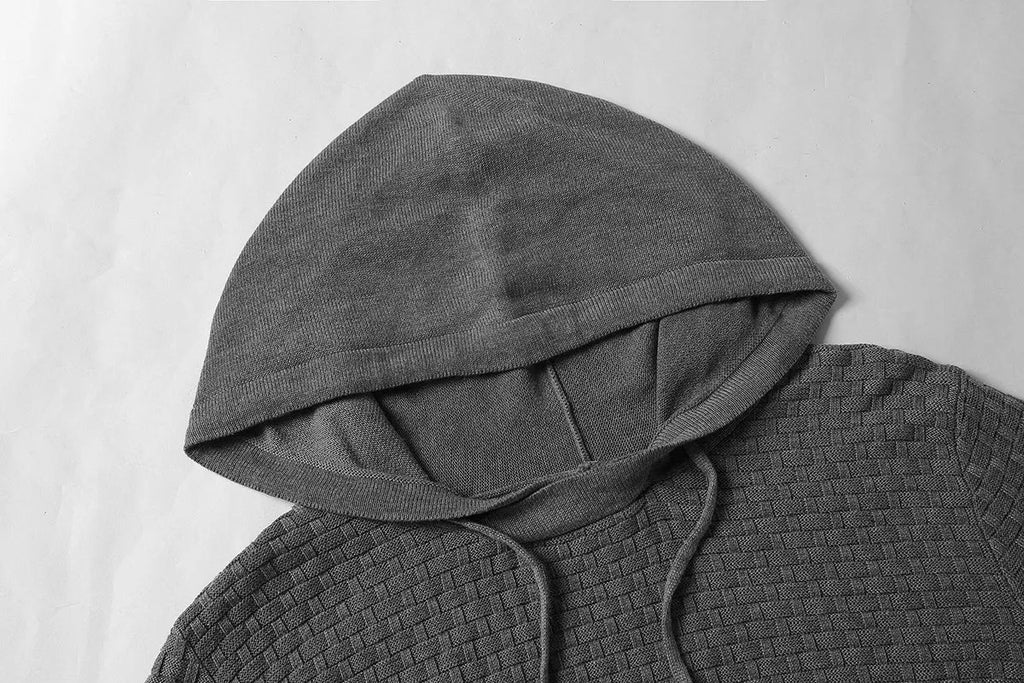 Man wearing a grey cotton-polyester blend hooded sweatshirt, showcasing the casual hoodie design.