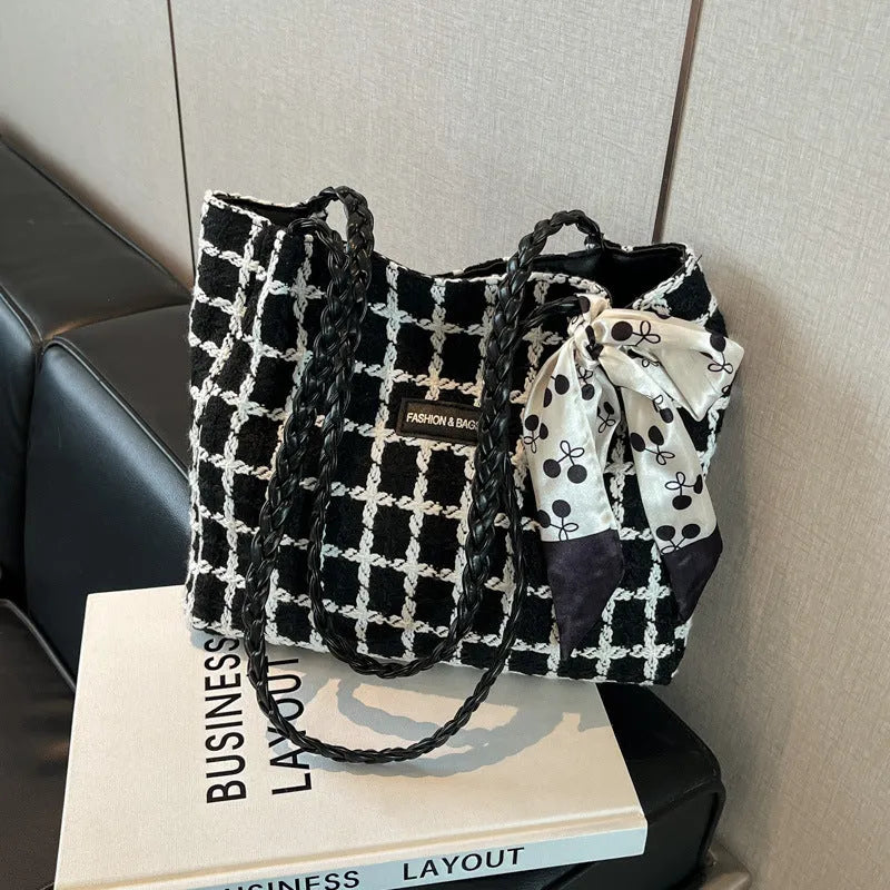 Black woolen shoulder bag with weaving details showing sandwich pocket exterior and interior organisation compartments
