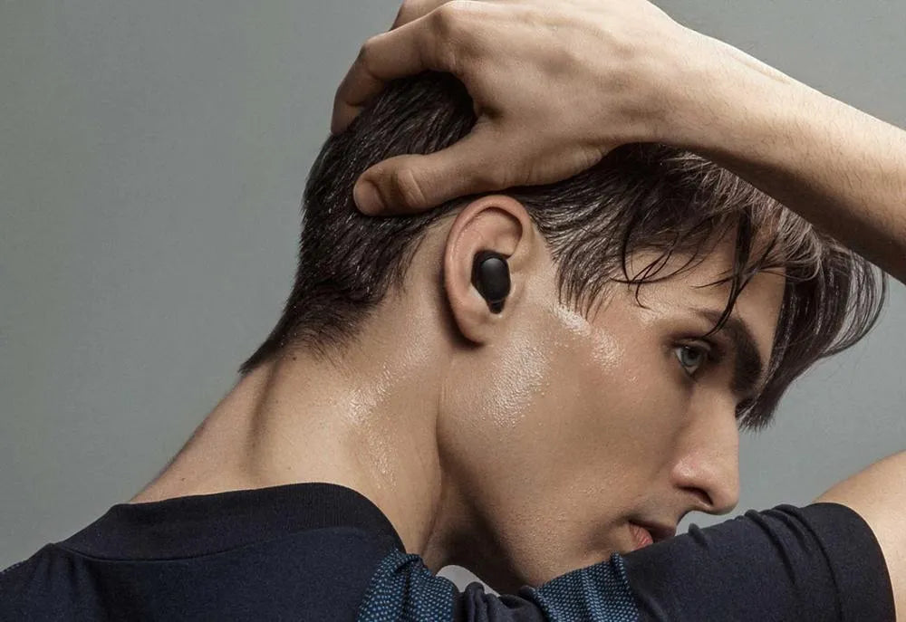 Redmi AirDots True Wireless black earbuds and charging case with three earplug sizes.
