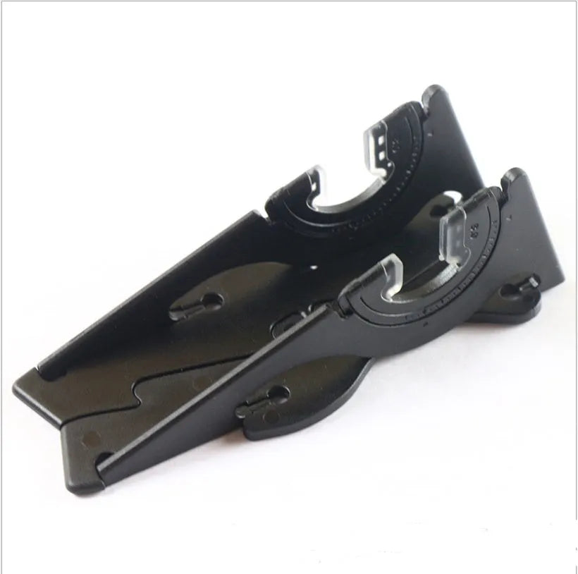 Black plastic card-type mobile phone holder on a desktop