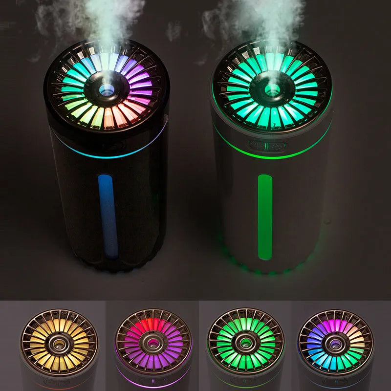 Black portable car humidifier with colourful LED lights showing mist output, placed in vehicle cup holder