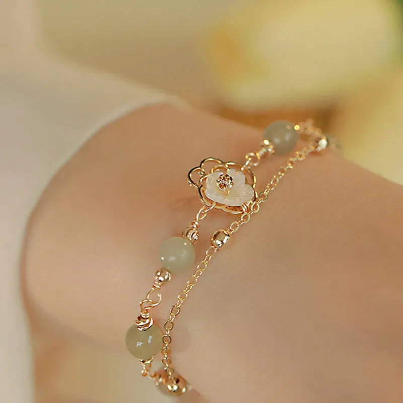 Women's copper butterfly bracelet with electroplated yellow gold finish and geometric design