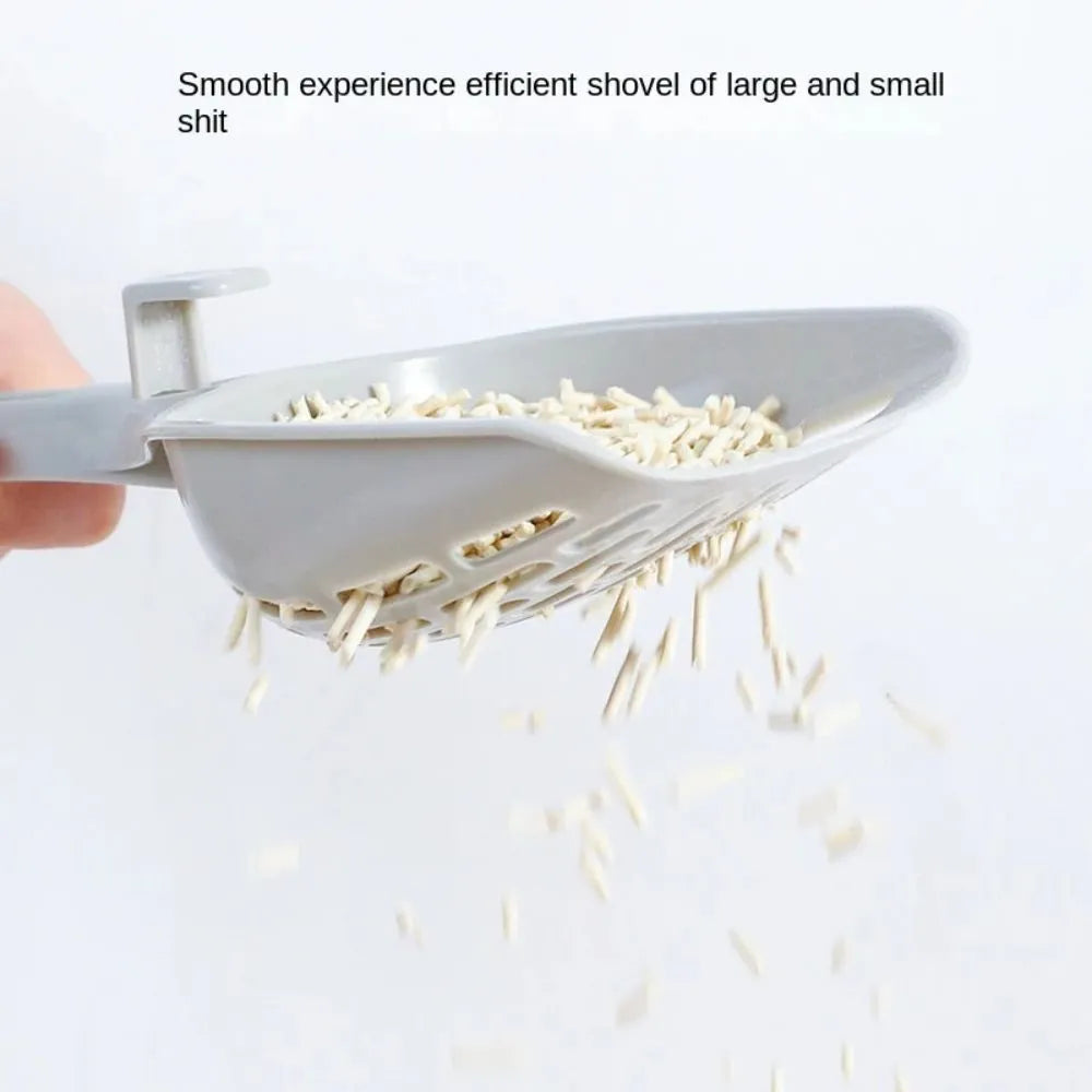 Grey plastic cat litter scoop with a built-in self-cleaning base and removable waste tray.