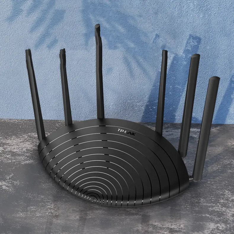 TP-Link TL-WDR7661 black AC1900 gigabit wireless router with antennas on a desk.