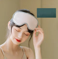 Pink and green portable eye spa mask with USB cable for steam heat and vibration massage.