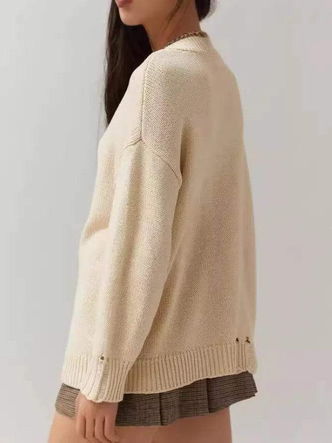Women's loose-fitting round neck acrylic sweater with jacquard knit texture in a beige colour.