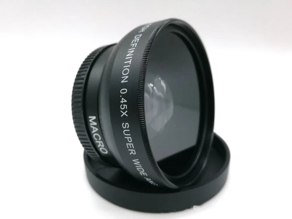 Black 52mm wide-angle macro camera lens with front and back covers on a table
