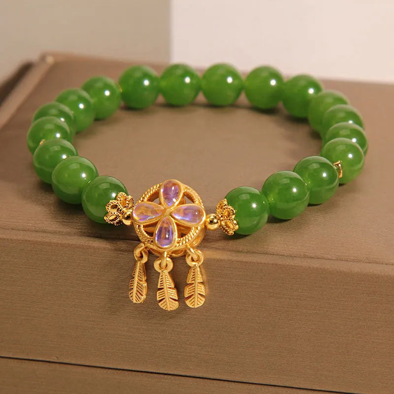 Green Jasper Crystal four-leaf clover dreamcatcher pendant on a women's bracelet.