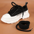 Round white woven shoelace on a grey background showing its 10mm diameter and textured weave.