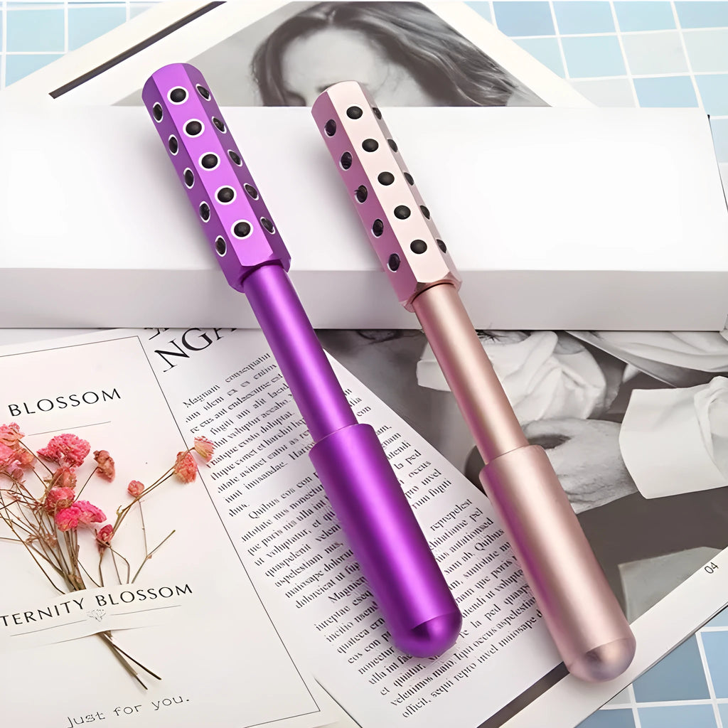 Germanium particles roller beauty massage instrument in purple colour on a white background.