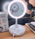 White foldable double-sided LED vanity mirror with USB charging port and storage compartments