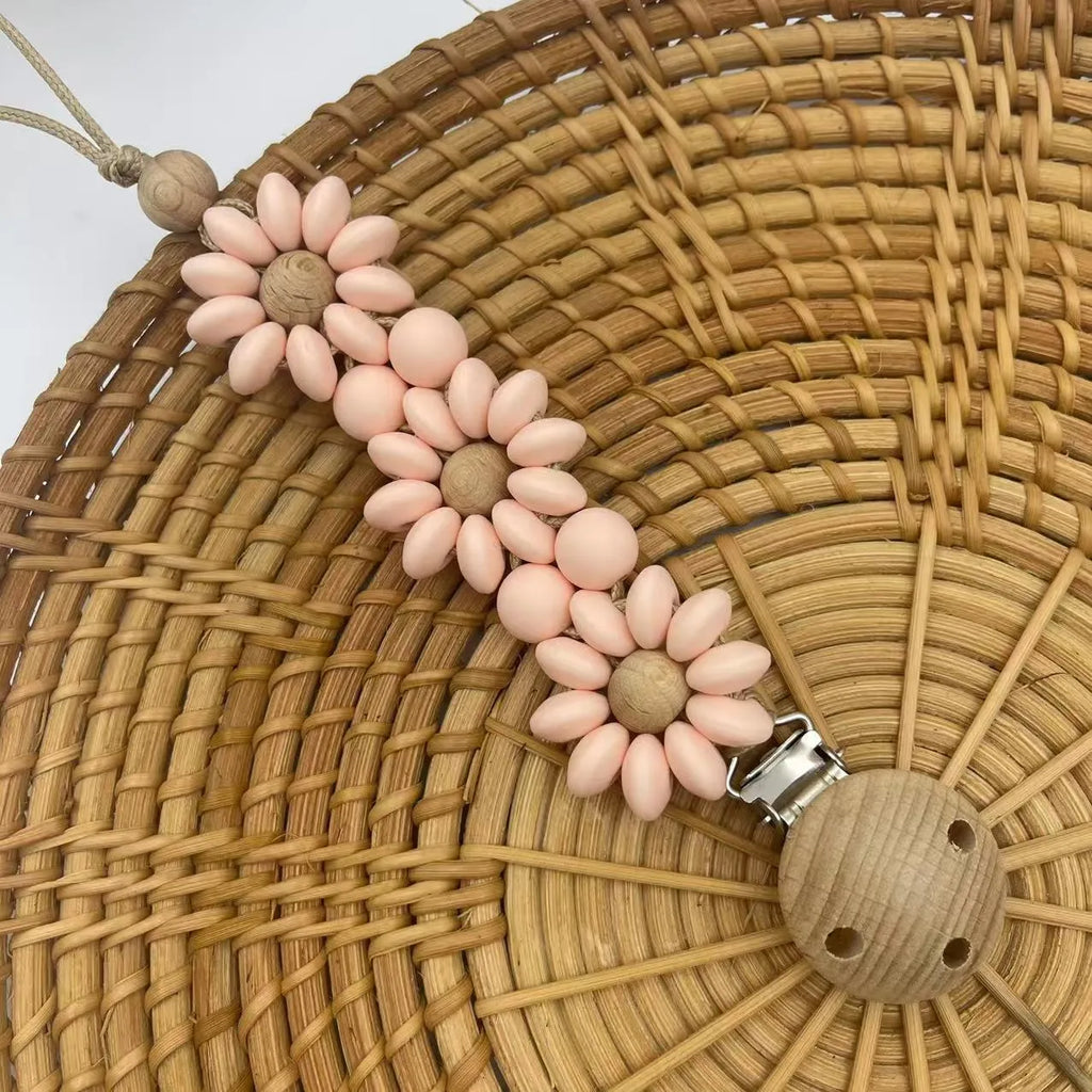 Silicone flower-shaped pacifier clip in Baby Pink with small beads and metal clip mechanism