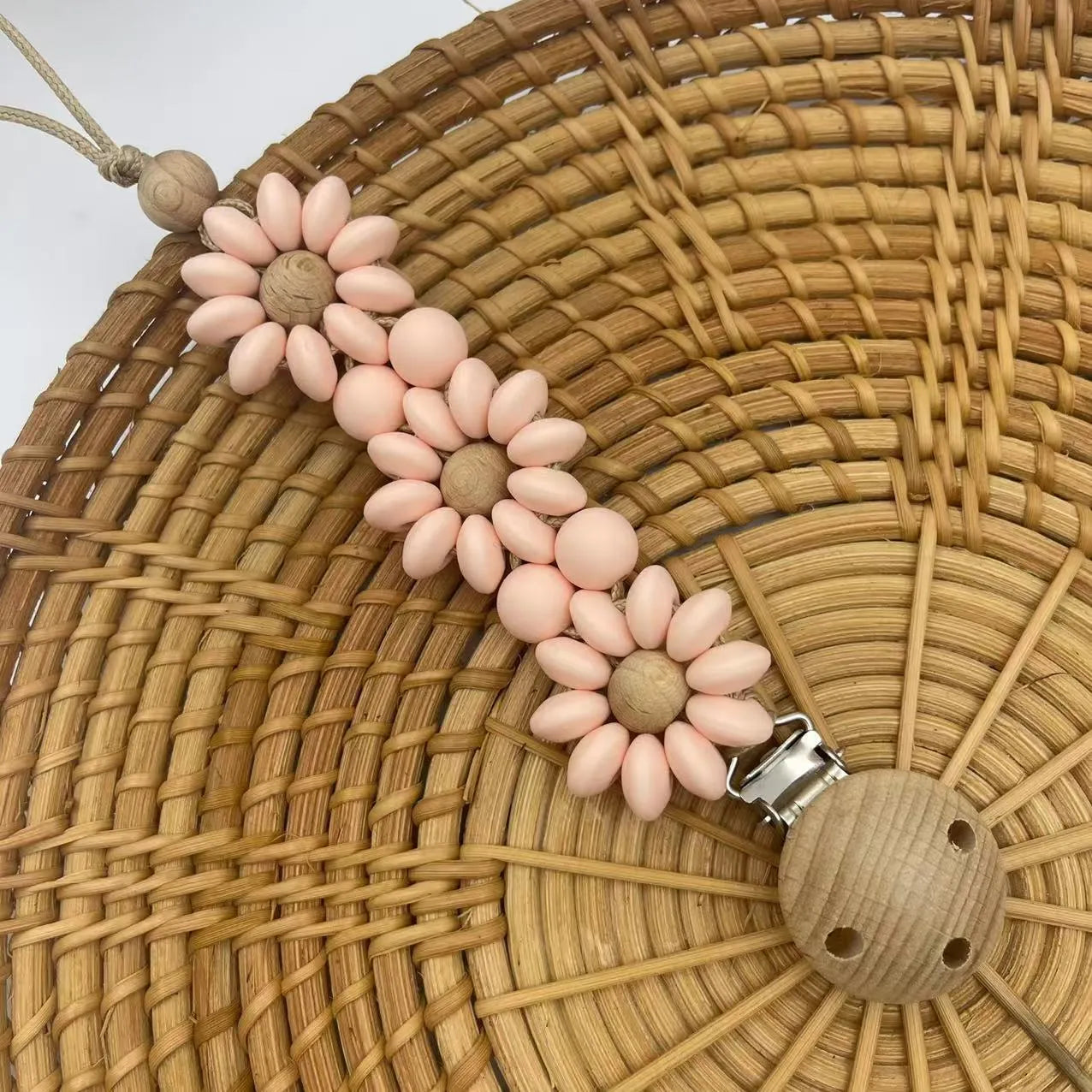 Silicone flower-shaped pacifier clip in Baby Pink with small beads and metal clip mechanism