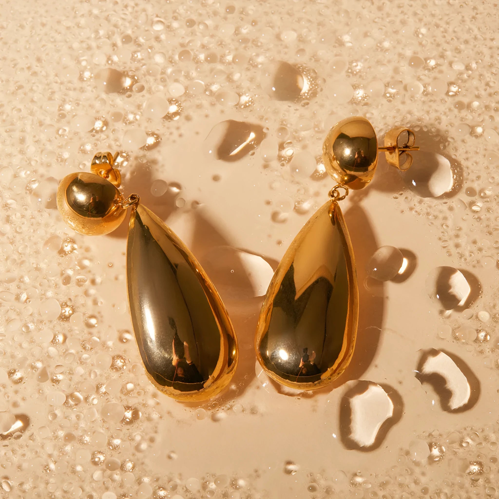 Gold geometric water drop earrings with hemispherical stainless steel construction