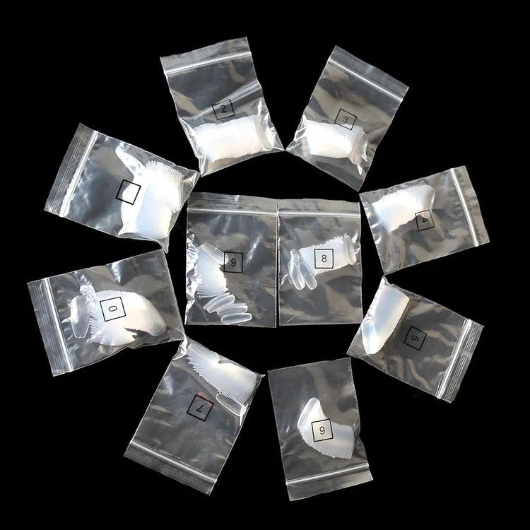 500 transparent and natural coloured ABS false nails in ten sizes, packaged in small bags.