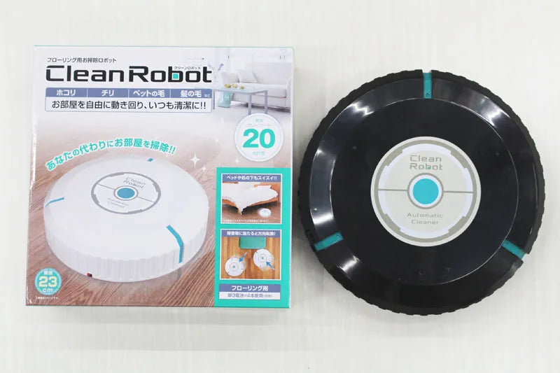 Black or white compact robot vacuum cleaner on a hardwood floor.