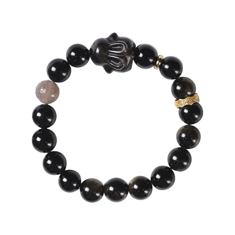 Handmade Chinese style bracelet with lying rabbit charm, grey agate bead, and brass on a black background.