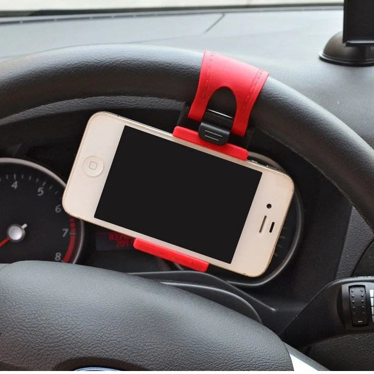Black universal steering wheel phone holder clip mounted on a car steering wheel.