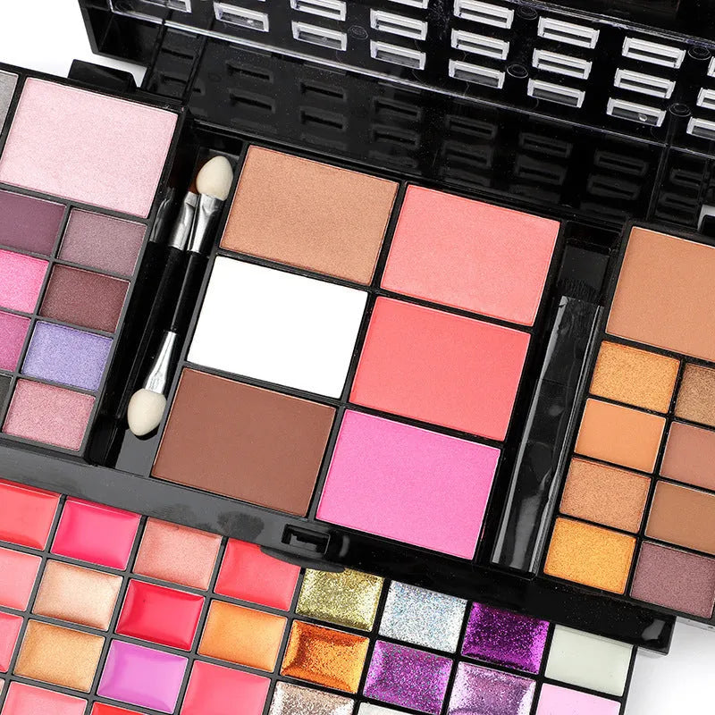 74 colour makeup palette open showing eyeshadow, lip gloss, blush and contour powders with brush and applicator