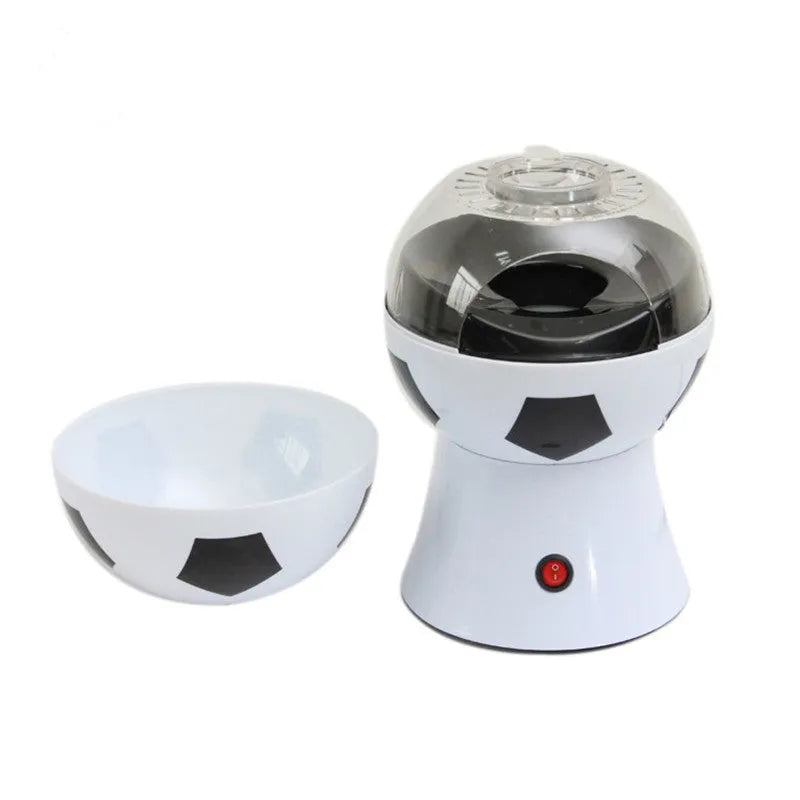 Black football-shaped electric popcorn machine with round insert and popcorn collector bowl