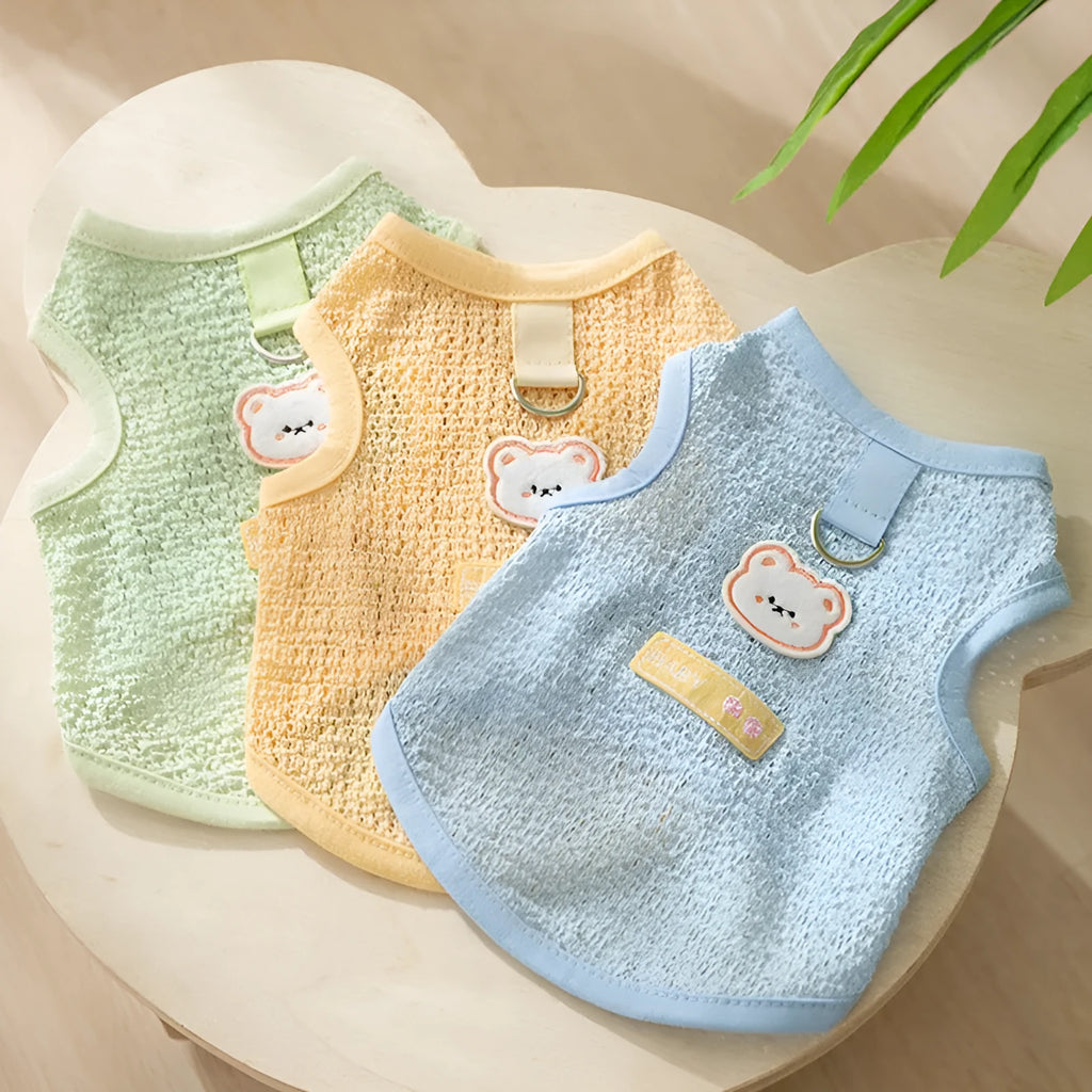 Cat wearing blue knitted clothing with bear patch and hollowed-out breathable design