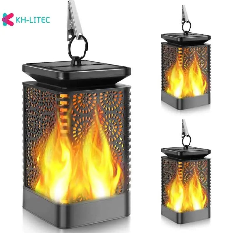 Four black solar-powered flame torch lights with flickering LED effect for garden decoration
