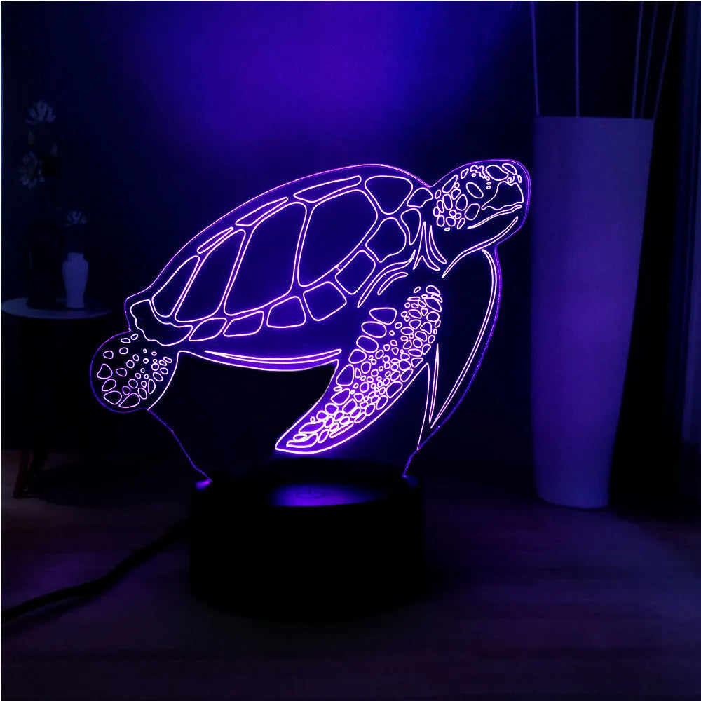 3D acrylic turtle-shaped night light glowing with multi-coloured LED light.