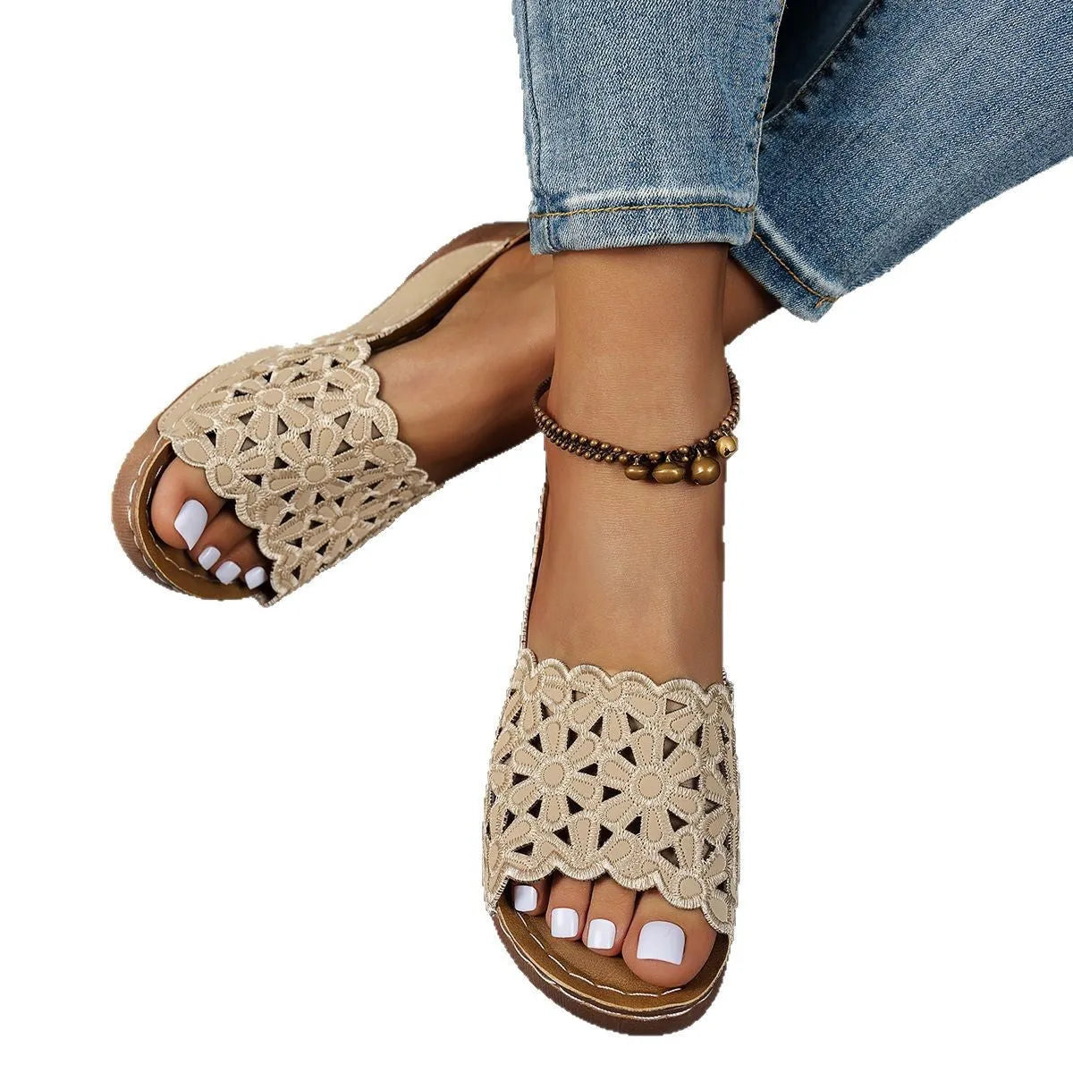Women's wedge heel beach slippers with flower cutout design on black PVC upper.