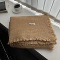 Four-layer cotton gauze blanket with tassel edge in a choice of ten colours.