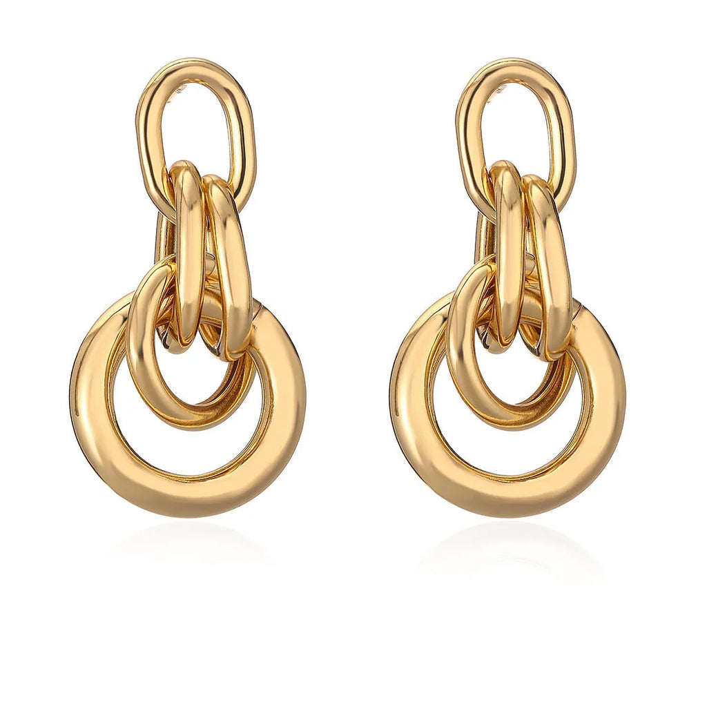 Geometric gold-colour drop earrings with irregular details and high-profile construction