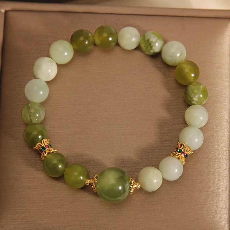 Original design women's bracelet with a single green Xiuyan jade stone in a Mori style.