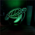 3D acrylic turtle-shaped night light glowing with multi-coloured LED light.