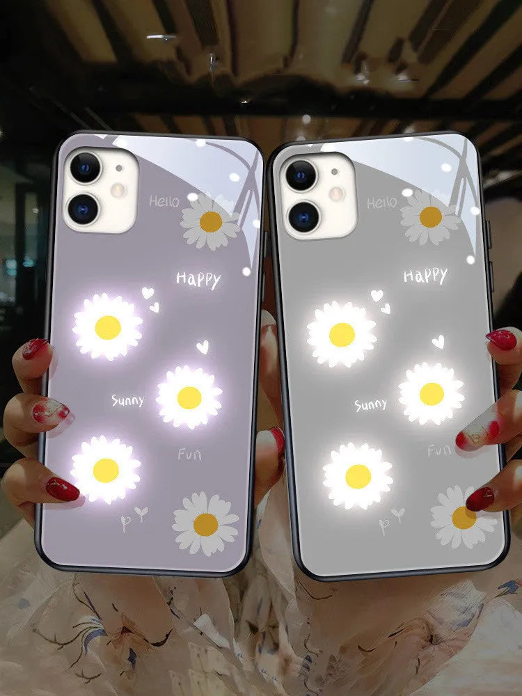 White voice-activated LED iPhone case with painted daisy and letter design, showing colour-changing lights.